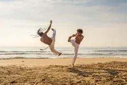 men-train-capoeira-on-beach-250nw-1331511881.webp